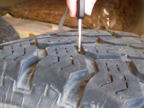 1991 Ford Bronco - A tire tread depth gauge is used to measure the remaining tread on a tire.