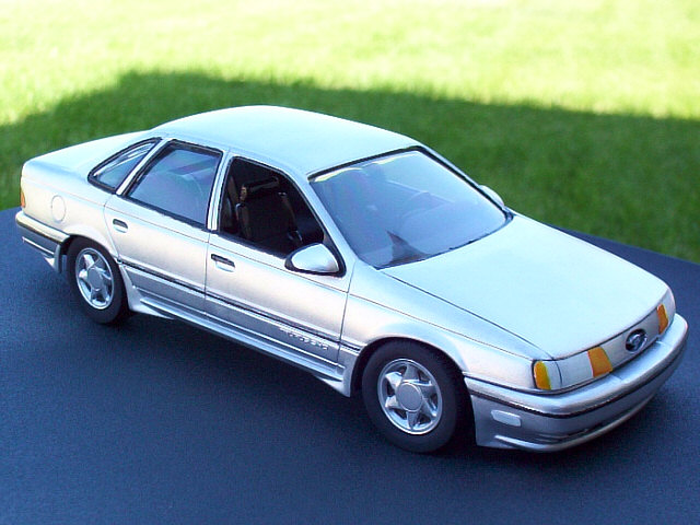Silver Ford Taurus SHO scale model on grass, front three-quarter view