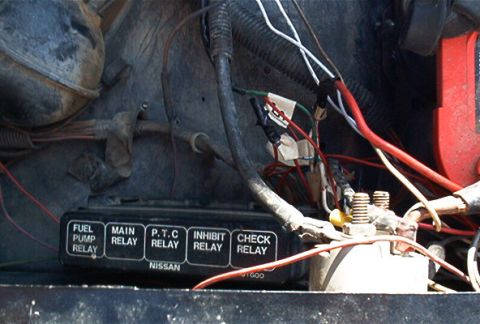 1986 Ford Bronco - This image shows a NISSAN branded fuse box with various relays, including fuel pump, main, P.T.C., inhibit, and check relays.