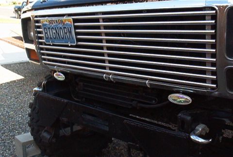1986 Ford Bronco - Front view of a black Ford Bronco's chrome grille and Nevada license plate.