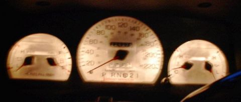 1985 Mercury Grand Marquis - Illuminated car dashboard gauges including speedometer, fuel, and temperature indicators.