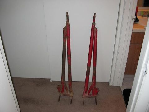 1991 Ford Bronco - A pair of red metal jack stands are shown indoors on a carpeted floor.