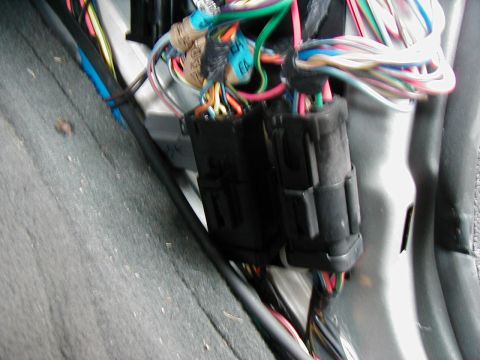 2002 Ford Excursion - Close-up of a vehicle's electrical wiring harness and connectors, with some labels visible.
