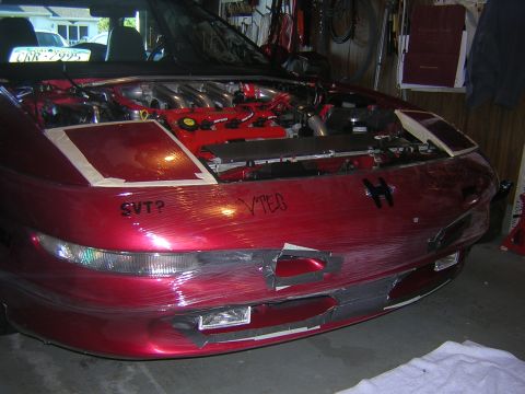 1995 Ford Probe - A red 1995 Ford Probe is shown with its hood open and front bumper covered in protective plastic wrap.