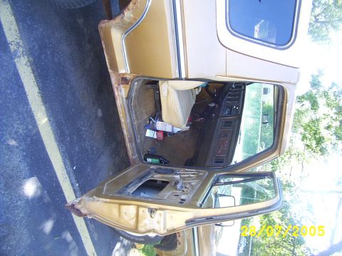 1979 Ford Bronco - Interior view of a 1979 Ford Bronco, door removed, showing seats and dashboard.