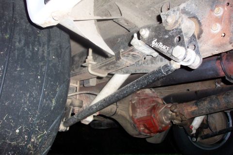1994 Ford F-150 - Close-up view of the rear axle and suspension components, including a "CALTRACS" traction bar.