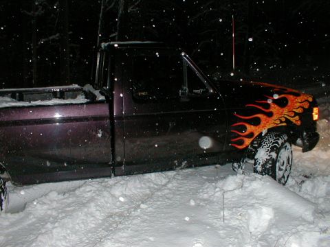 1991 Ford F-150 - Purple 1991 Ford F-150 with flame decals is stuck in deep snow.