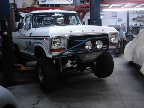 1978 Ford Bronco - This modified Ford pickup truck is in a garage, possibly undergoing repairs or upgrades.