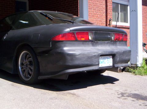 1993 Ford Probe - Rear view of a black coupe with an Ontario license plate.