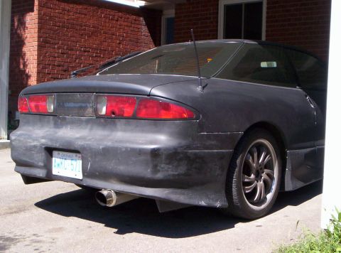1993 Ford Probe - Rear view of a 1993 Ford Probe with custom body kit and exhaust pipe.