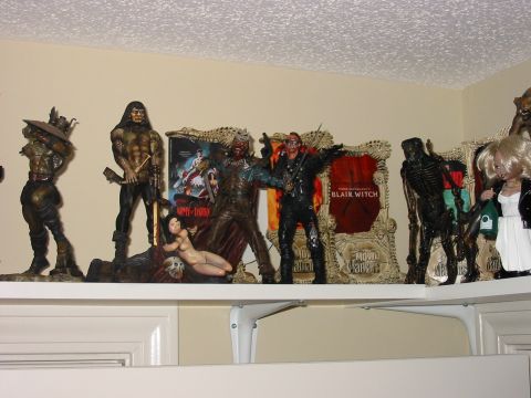 1991 Ford Bronco - Various horror movie collectible figures are displayed on a shelf, some with movie posters in the background.