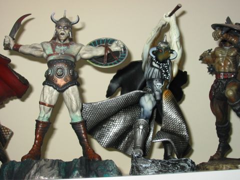 1991 Ford Bronco - Fantasy action figures depicting warriors in battle poses are displayed on a shelf.