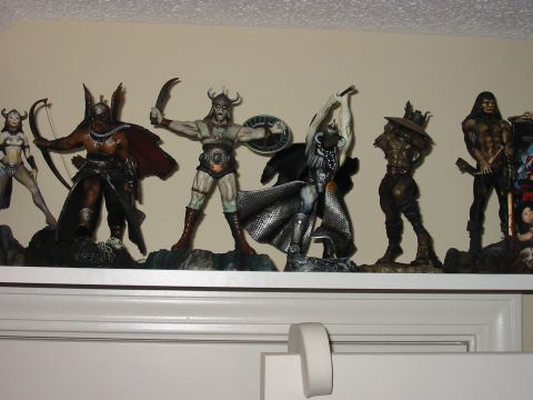 1991 Ford Bronco - Several fantasy warrior figurines are lined up on a shelf against a light-colored wall.