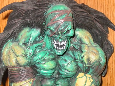 1991 Ford Bronco - A close-up of a green, muscular monster figurine with a skull-like face and dark, flowing hair.