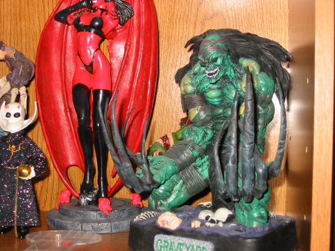 1991 Ford Bronco - A collection of comic book character figurines displayed on a shelf, a green monster and a red-clad female figure.