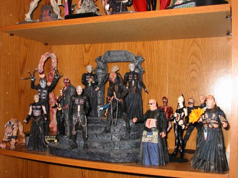 1991 Ford Bronco - A display of various action figures, primarily from the Hellraiser franchise, arranged on wooden shelves.