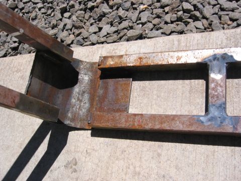 1991 Ford Explorer - This rusted metal component, possibly a frame or bracket, shows signs of welding and modification.