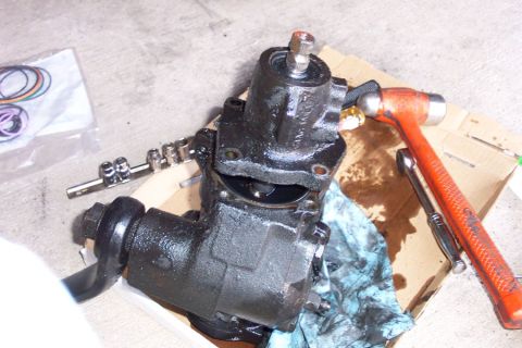 1992 Ford Bronco - Separate the valve body. Just underneath it, there is an allen-head set screw. Remove this, and then you can use a drift and hammer to remo…