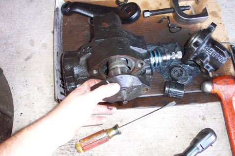 1992 Ford Bronco - Remove the two bolts that hold the sector shaft in, then drive it up from the bottom. Do NOT remove the adjusting nut like I did. The secto…