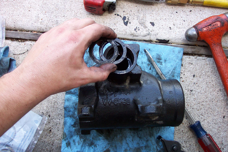 Remove the o-ring over the sector shaft, then remove the seals.  You may have to use a pick to remove the rubber around the o-ring in order to compress it enough.  You'll see what I mean when you try it.