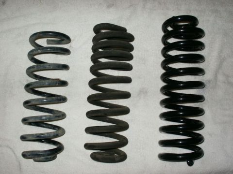 1996 Ford Bronco - Three suspension coil springs are displayed, showing variations in size and condition.