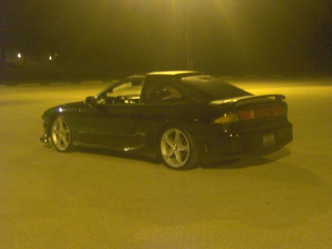 1994 Ford Probe - This black coupe has a distinctive spoiler and aftermarket wheels.