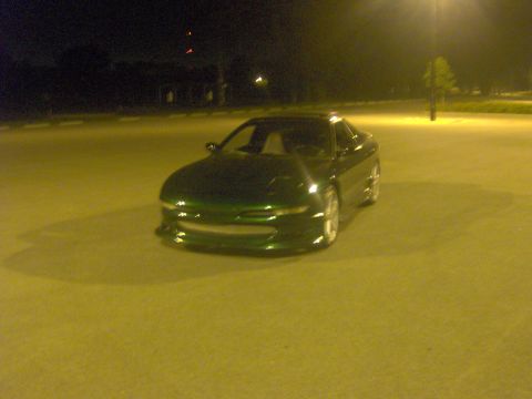 1994 Ford Probe - A green 1994 Ford Probe is parked in a lot at night under streetlights.
