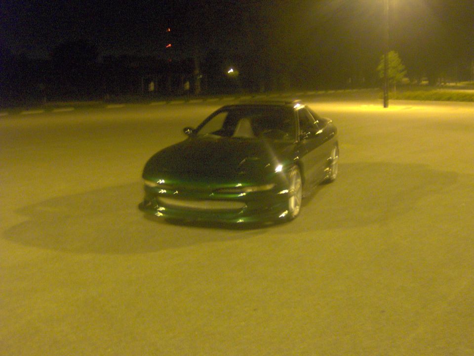 1994 Ford Probe coupe parked on asphalt at night