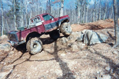 1985 Ford Bronco - A modified pickup truck navigates a rocky off-road course.