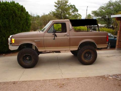 1989 Ford Bronco - Lifted 1989 Ford Bronco in a driveway, soft top removed.