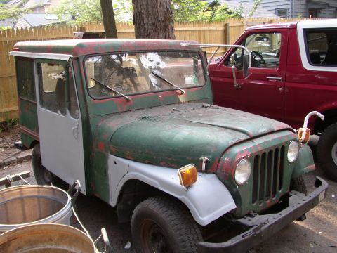 1973 Jeep CJ5 - This 1973 Jeep CJ5 has a unique custom utility body and is parked next to a red Ford Bronco.