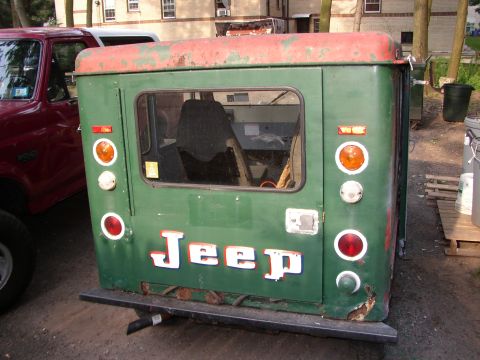1973 Jeep CJ5 - Rear view of a green Jeep CJ-5 hardtop with a red roof and "JEEP" lettering.
