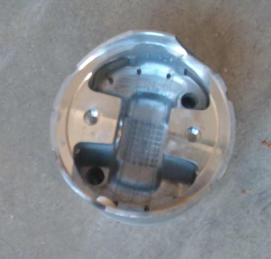 Piston with internal cross-hatching and bolt holes
