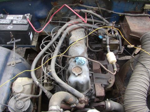 1973 Jeep CJ5 - Engine bay of a 1973 Jeep CJ5, showing the V6 engine and associated components.
