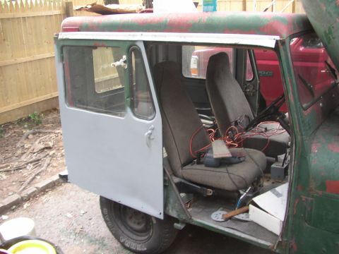 1973 Jeep CJ5 - Interior view of a 1973 Jeep CJ5, showing seats and the driver's side door.