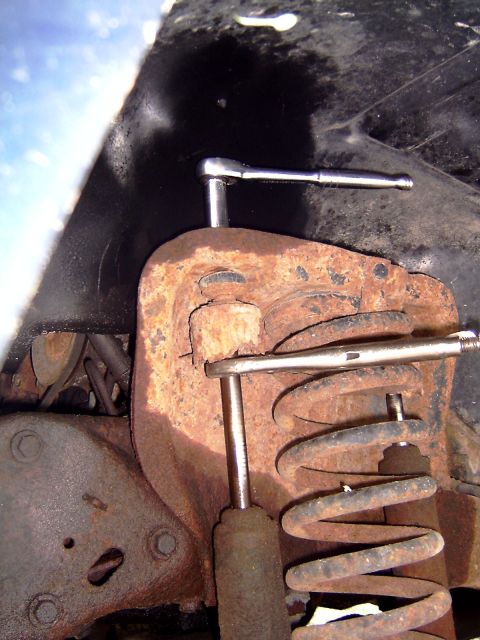 1981 Ford Bronco - Taking off the top bolt of the shock is really easy with a ratchet and a pair of vise grips.