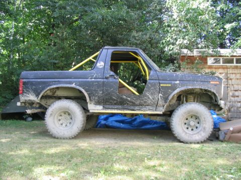 1986 Ford Bronco - This 1986 Ford Bronco features a yellow roll cage and is modified for off-road use.