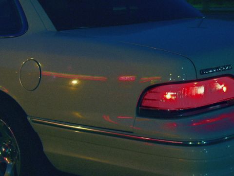 1993 Ford Crown Victoria - The neon signs reflecting off the paint. Note the dark blue twilight sky reflection on the trunk lid.