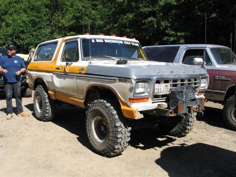 1989 Dodge Power Ram - A modified Ford Bronco with large tires and a custom front bumper is parked outdoors with another vehicle behind it.