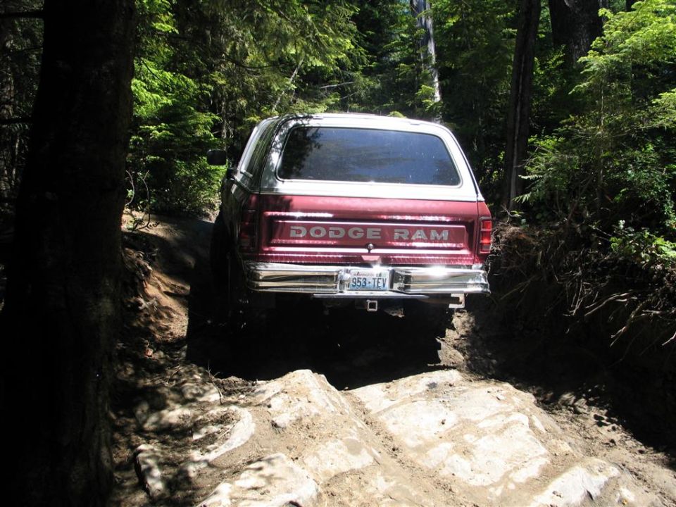 1989 Dodge Ram pickup truck, rear view, on a rocky dirt trail