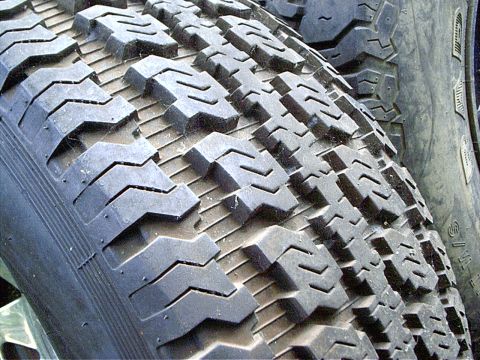 1979 Ford Bronco - The aggressive tread pattern on this tire is visible, but no vehicle details can be discerned.
