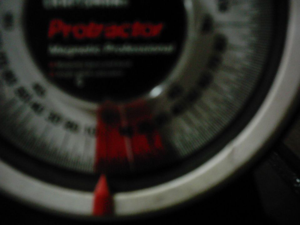 Gauge with red needle and 'Protractor' text