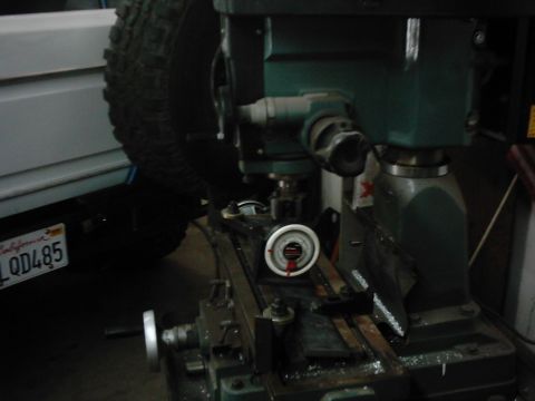 1978 Ford Bronco - A milling machine is in the foreground, with a vehicle tire and license plate in the background.