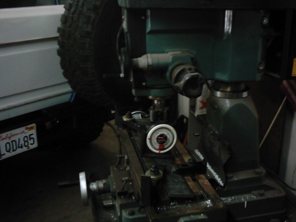 Milling machine with a tire and California license plate QD485 visible
