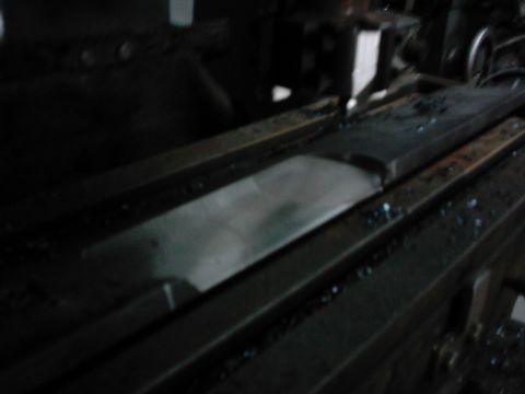 1978 Ford Bronco - A close-up view of a metal surface with debris on a machine tool, likely in a workshop setting.