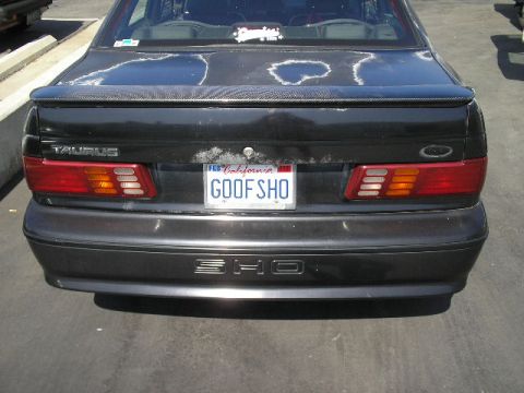 1991 Ford Taurus - The rear of a 1991 Ford Taurus shows its distinctive taillights, spoiler, and SHO badging.