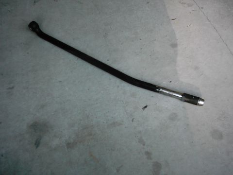 1978 Ford Bronco - A black metal rod with a silver end rests on a concrete surface. The registry suggests it is from a 1978 Ford Bronco.