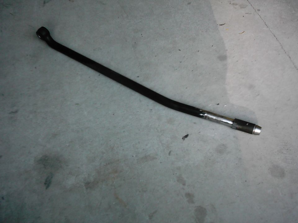 Black metal rod with silver end on concrete floor