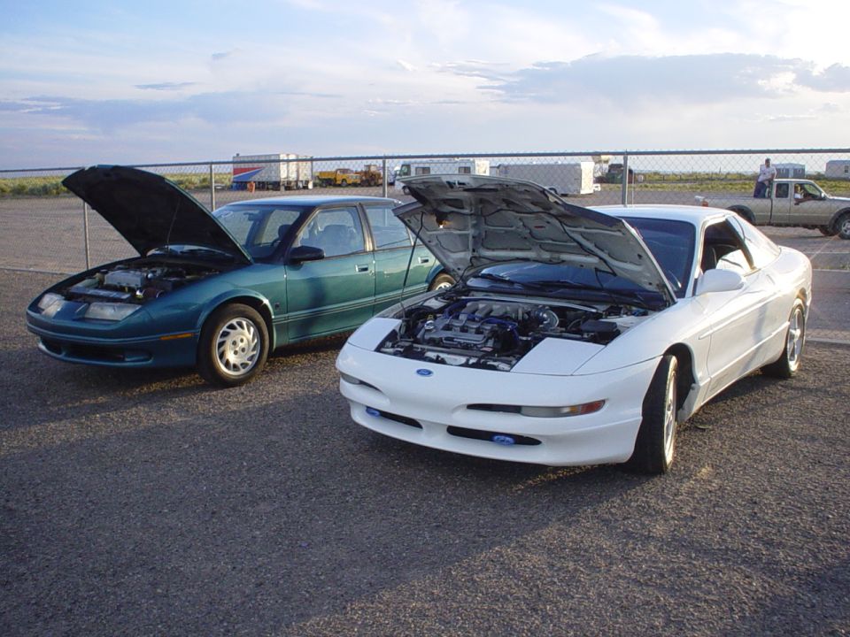White 1993 Ford Probe with hood open, front 3/4 view