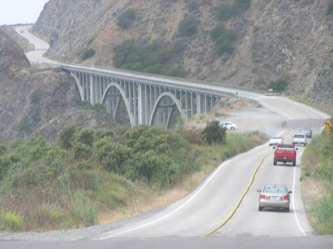 1993 Ford Taurus - Cars travel along a scenic route with a prominent bridge in the background.
